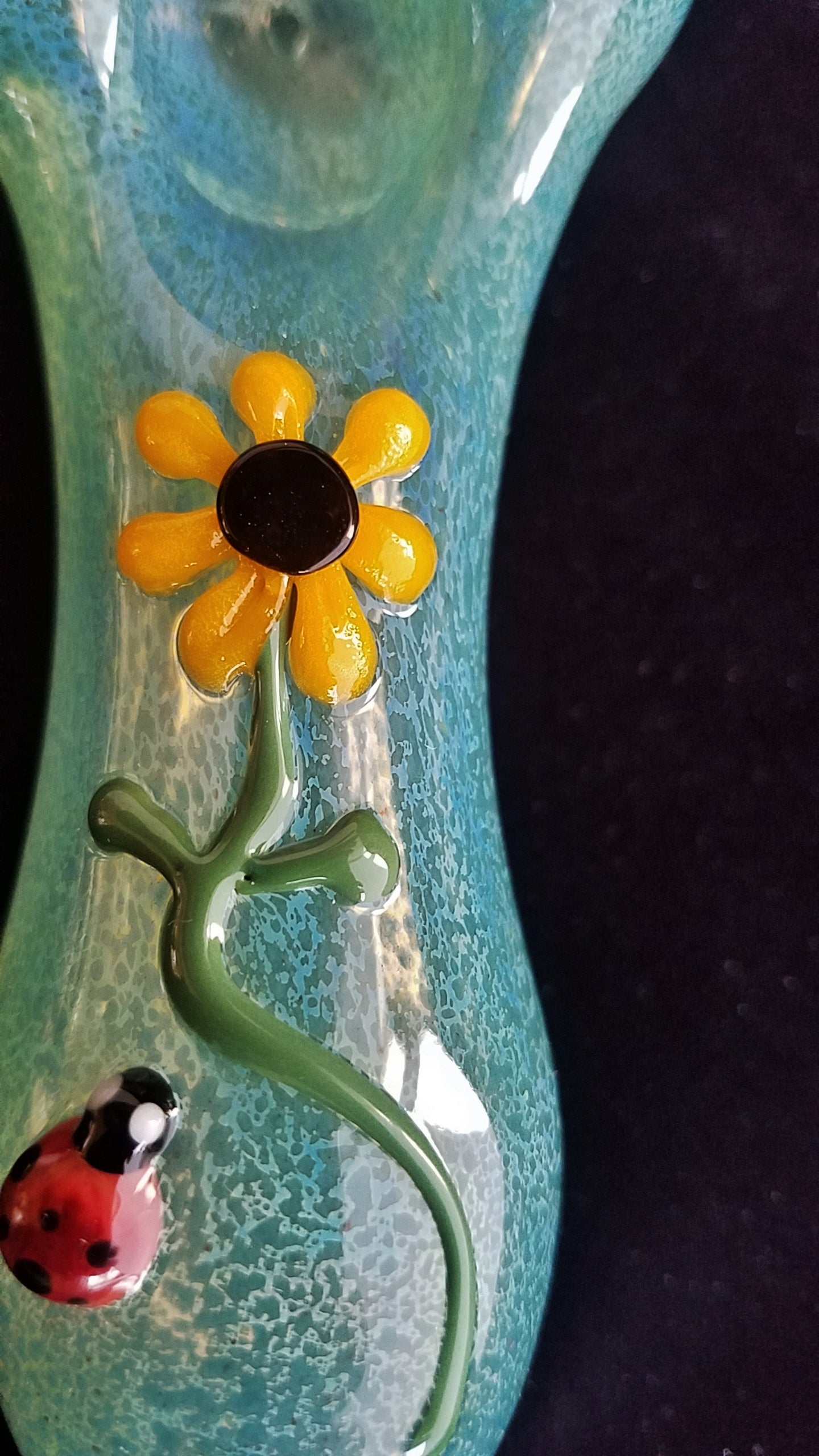 Beautiful hand blown glass pipe with ladybug and daisy decorations.
